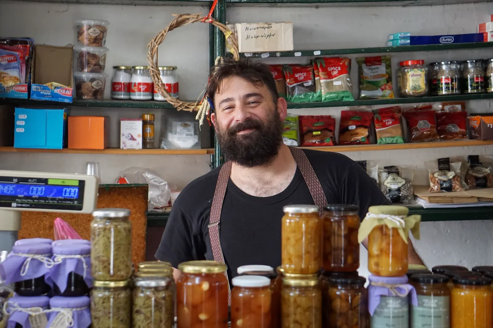 A store owner smiles behind the counter